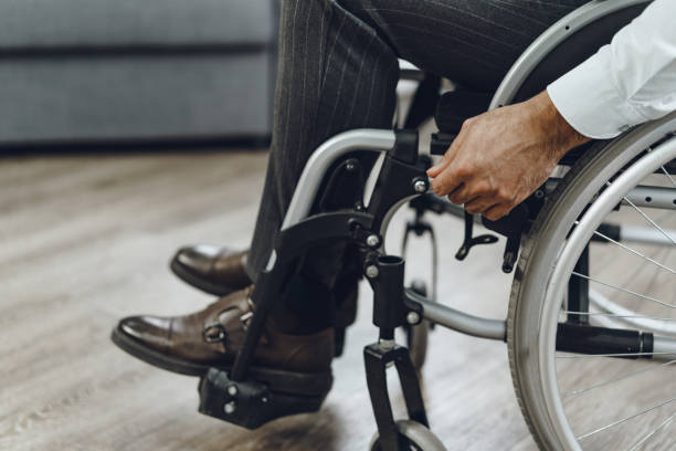 istock Unrecognizable man sitting in wheelchair close up 1301711645