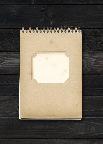 istock Closed spiral Note book on a black wood table 1301711681