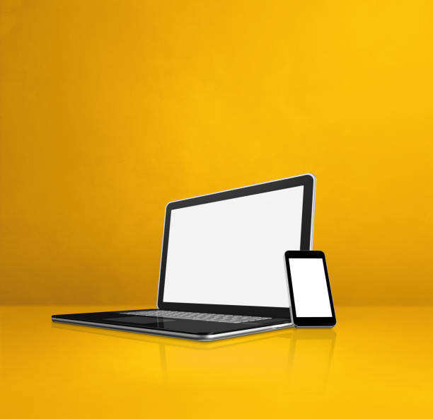 istock Laptop and mobile phone on yellow office desk 1301711768