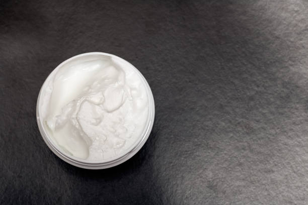 istock Jar of cream on a black background 1301715156