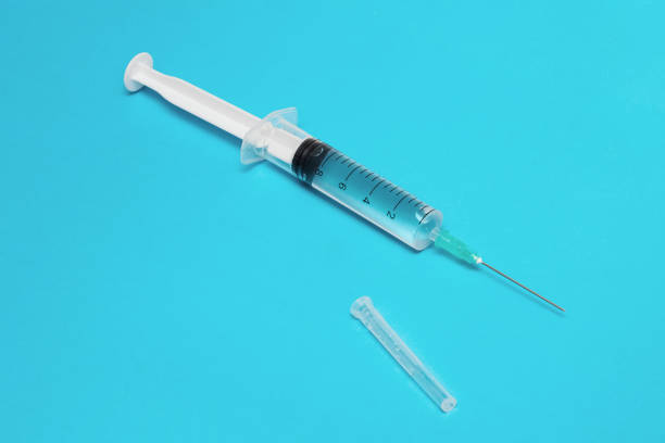 istock Syringe with medicine on a blue background 1301715799
