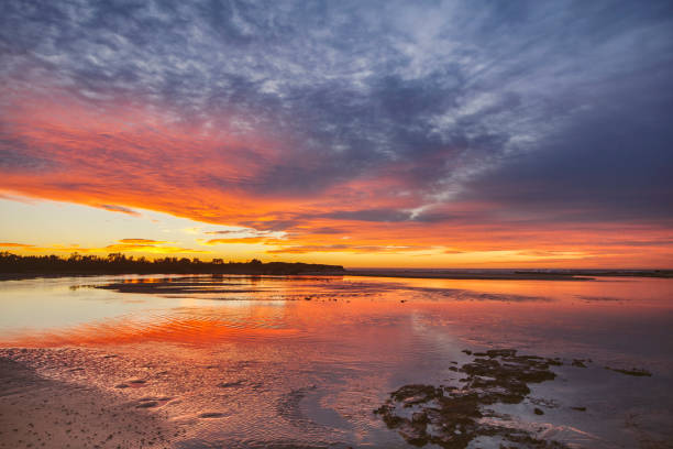 Coastal ocean estuary scene with dramatic morning sunrise, south coast, NSW, Australia