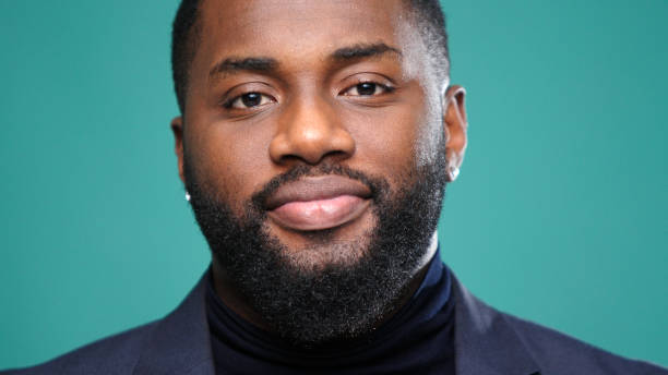 istock African American gentleman smiles gently looking into camera 1301718264