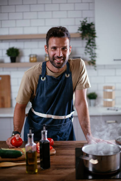 istock Portrait of handsome man cutting vegetables 1301718348