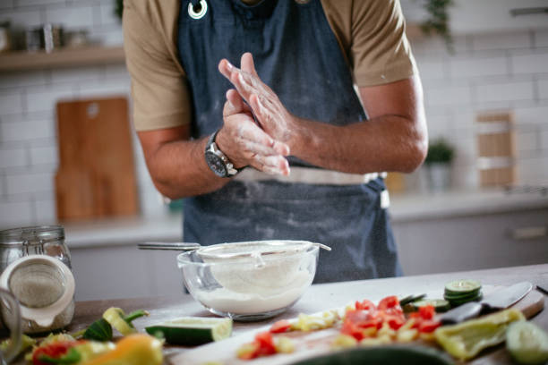 Close up of man baking in the kitchen.