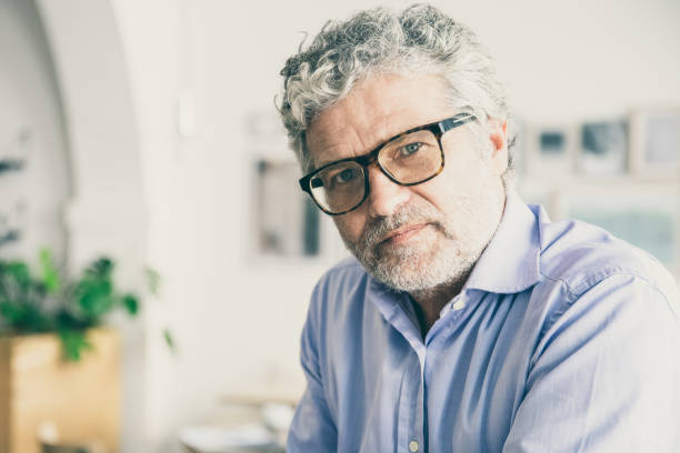 istock Serious pensive mature business man wearing shirt and glasses 1301719607