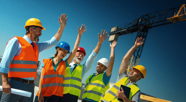 istock Group of contractors celebrating the end of successful construction process. 1301722993