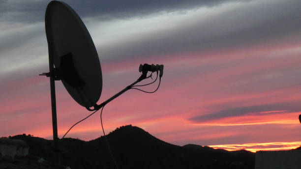 istock Red golden sunrise a satelite dish silhouette. 1301726104