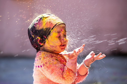 Boy Playing With colors in Holi festival India