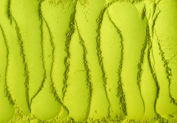 istock Matcha powder background. Green tea texture close-up, selective focus 1301728621