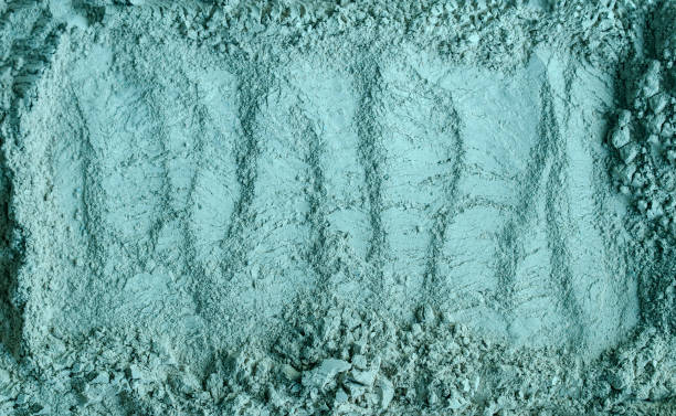istock Blue, green bentonite clay powder (alginate, facial mask, eye shadow, body wrap) texture close up, selective focus. Abstract background. 1301728636