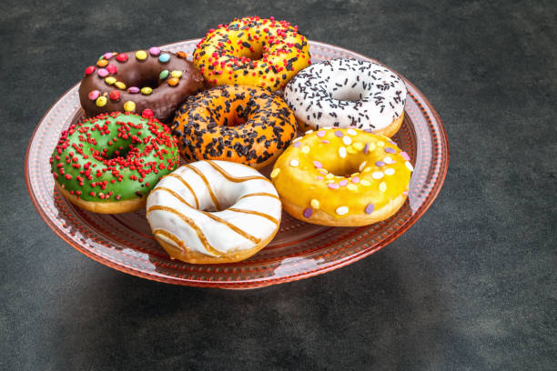 istock donuts with different flavors of frosting on a platter 1301730468