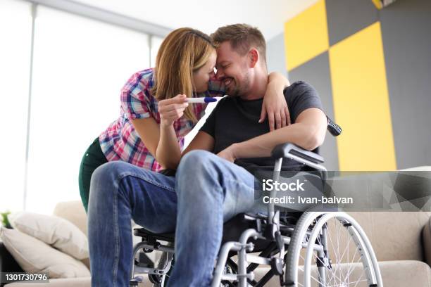 Joyful Woman And Man In Wheelchair With Pregnancy Test Stock Photo - Download Image Now
