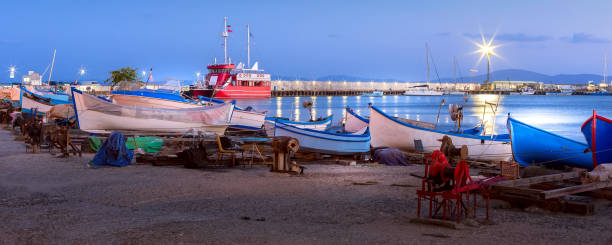 Pomorie, Bulgaria boats banner panorama, blue hour Pomorie, Bulgaria beachfront sea panoramic banner with boats in the town and seaside resort on Black sea, blue hour dusk view pomorie stock pictures, royalty-free photos & images