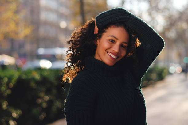 istock Woman smiling while posing outdoors. 1301732030