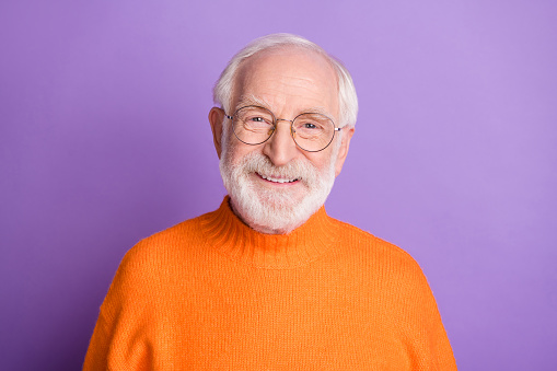 Portrait of satisfied aged person smile look camera wear pullover isolated on pastel purple color background.