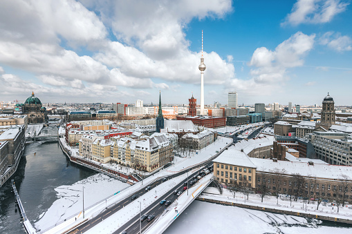 panoramic view over snowy Berlin cityscape with Cathedral TV-tower and River in winter