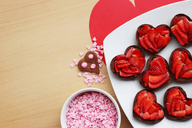 istock Valentine’s day dessert with copy space. Mini heart shaped chocolate tarts 1301736825