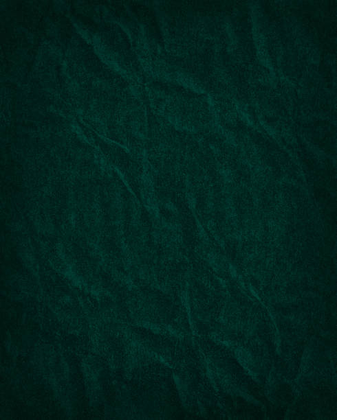 istock Dark emerald crumpled paper background with vignette. Vertical photo 1301738282