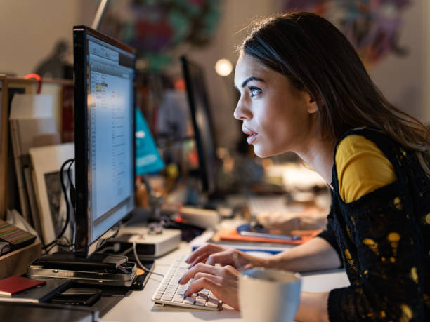 istock Female programmer staring at computer monitor while working in the office. 1301738412