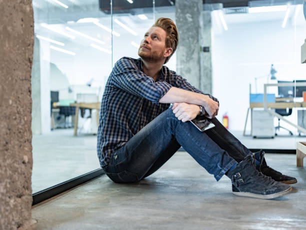 istock Young freelancer resting on the floor in the office. 1301738553