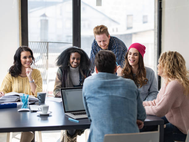 istock Young happy freelancers talking while working at casual office. 1301738617