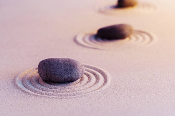 istock Zen garden stones on sand with ornament 1301739369