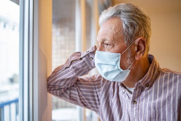 istock Portrait of senior man with a protective face mask 1301740529