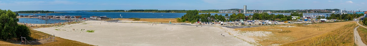 Panorama photo of lake with people swimming