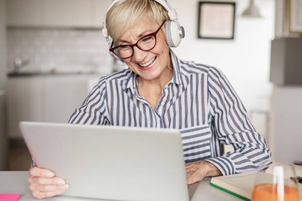istock Senior woman is working from home 1301740919