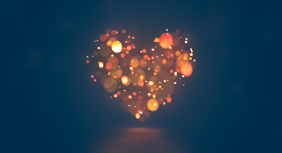Shining bokeh heart on dark blue background. This file is cleaned and retouched.