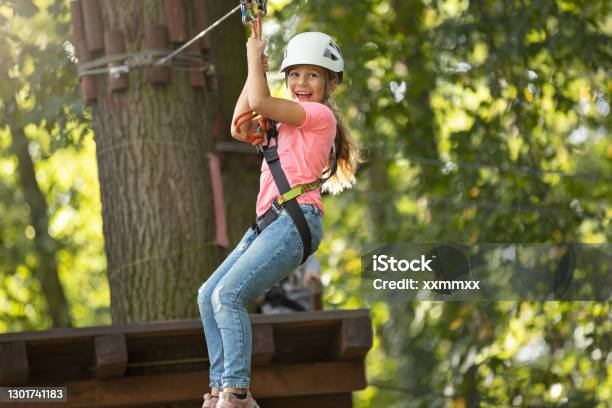 Cute Little Girl Climbing In Adventure Park Stock Photo - Download Image Now - Zip Line, Child, Girls