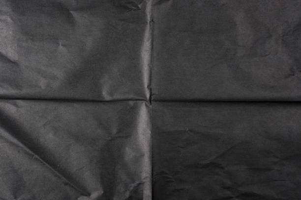 istock Black paper with folds. Paper texture. 1301741981