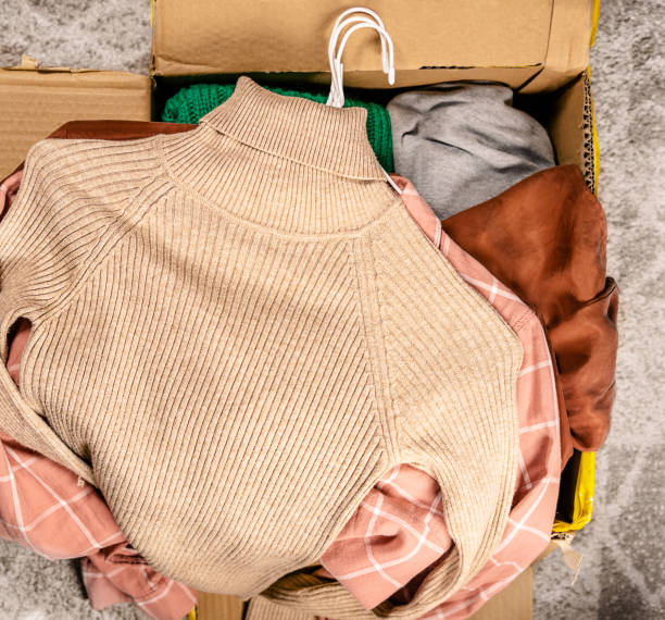 istock Top view at clothes in cardboard box 1301742192