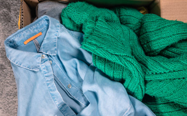 istock Top view at clothes in cardboard box 1301742195