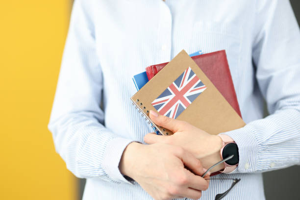 istock Female silhouette holding diaries with British flag 1301742558