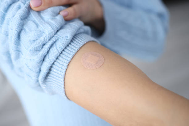 istock Female hand after vaccination with sealed plaster 1301742569