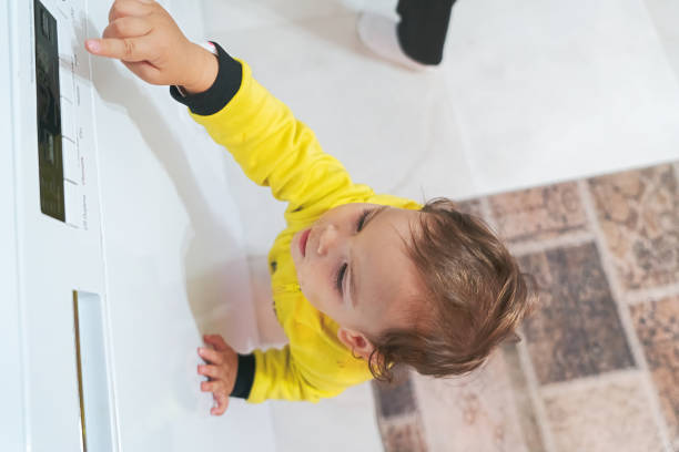 istock Naughty baby curios about kitchen whitegoods 1301743351