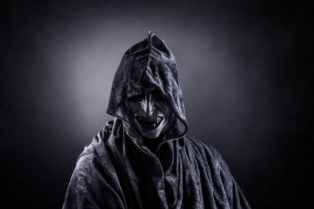 istock Angry vampire with cape showing his scary teeth 1301743877