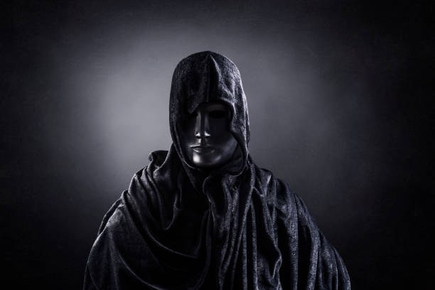 istock Scary figure with hooded cape in the dark 1301743936