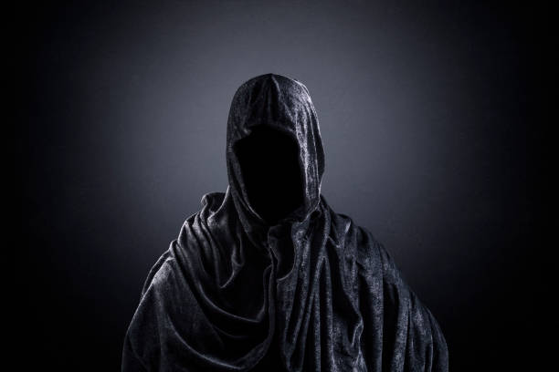 istock Scary figure with hooded cape in the dark 1301743993