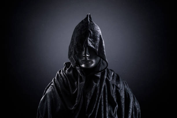 istock Scary figure with hooded cape in the dark 1301744031