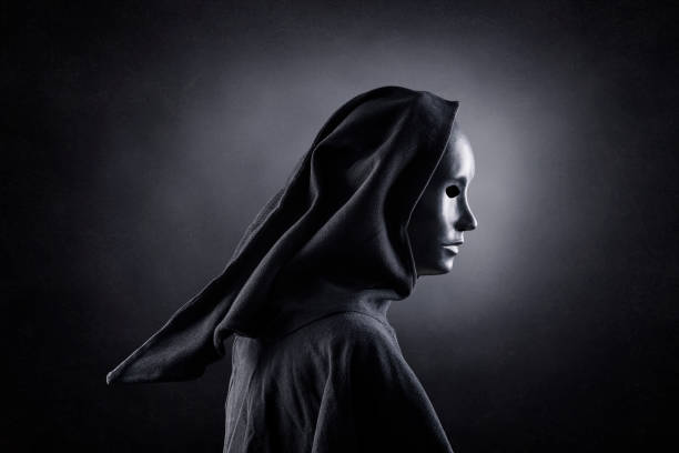 istock Scary figure with hooded cloak in the dark 1301744049