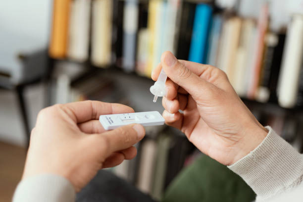 istock man using a covid-19 rapid antigen test at home 1301744660