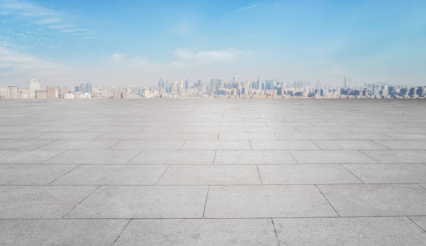 istock Square brick ground and urban buildings 1301745753