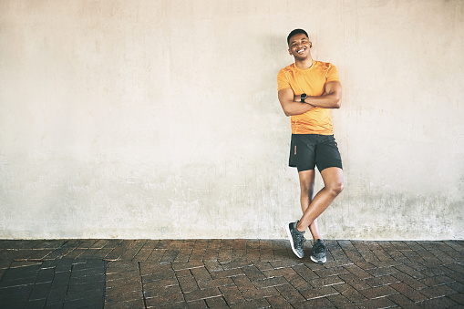 Portrait of a confident young man having a workout against an urban background