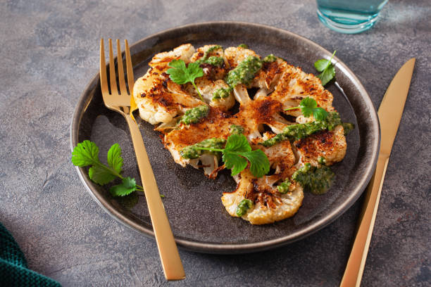 istock cauliflower steaks with herb sauce and spice. plant based meat substitute 1301747422