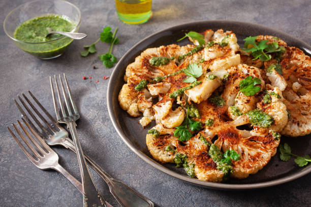 istock cauliflower steaks with herb sauce and spice. plant based meat substitute 1301747437