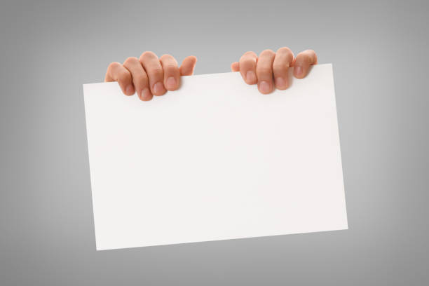 Two hands holding white sheet horizontally on top isolated background