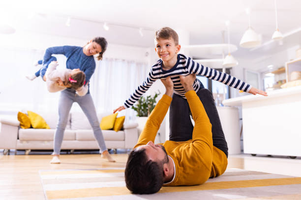 istock Playful parents having fun with their kids at home. 1301749851
